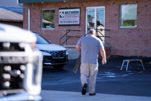 Person walking toward the entrance of Biltwood Powder Coating at 207 N Franklin Street in Waynesboro, PA.